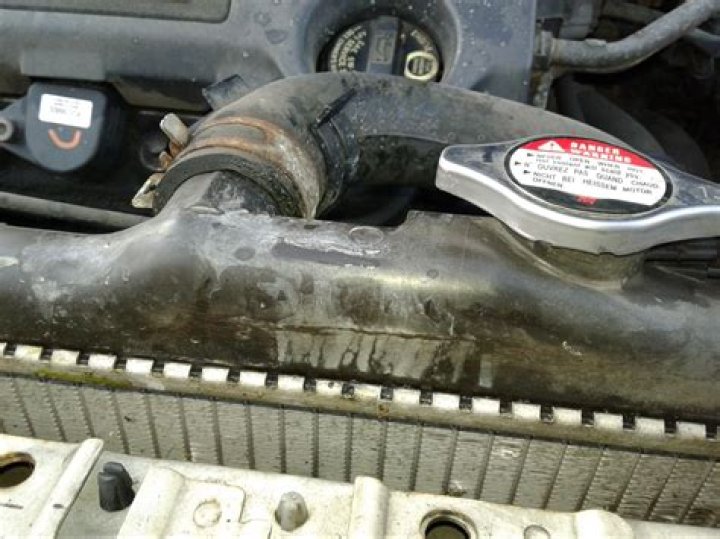 Can a cracked radiator cause coolant leak?