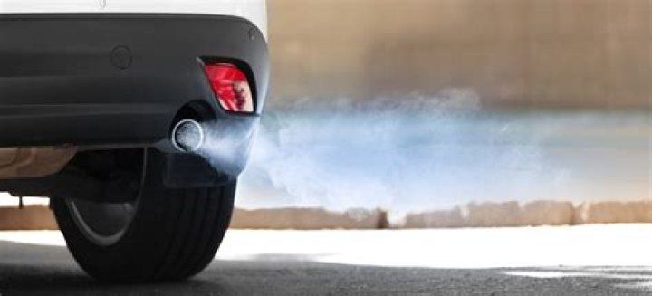 What causes flames to shoot out of the exhaust?